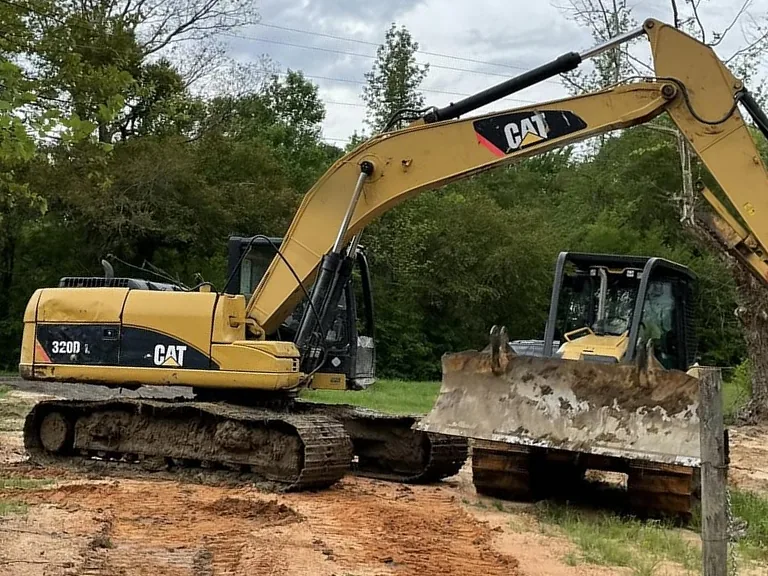 Excavator and crawler dozer on freshly graded red clay, dirt work